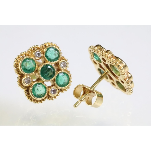 308 - Pair of 18ct gold, emerald and diamond cluster earrings. The earrings set with five round cut emeral... 