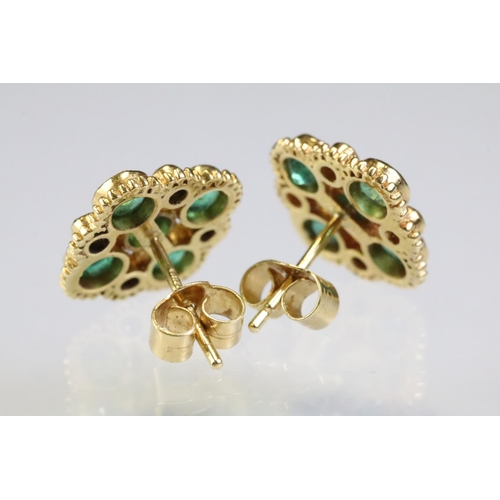 308 - Pair of 18ct gold, emerald and diamond cluster earrings. The earrings set with five round cut emeral... 