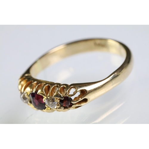 311 - 9ct gold garnet and diamond five stone ring. The ring being set with three round cut garnets with tw... 