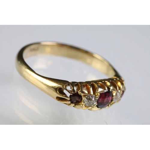 311 - 9ct gold garnet and diamond five stone ring. The ring being set with three round cut garnets with tw... 