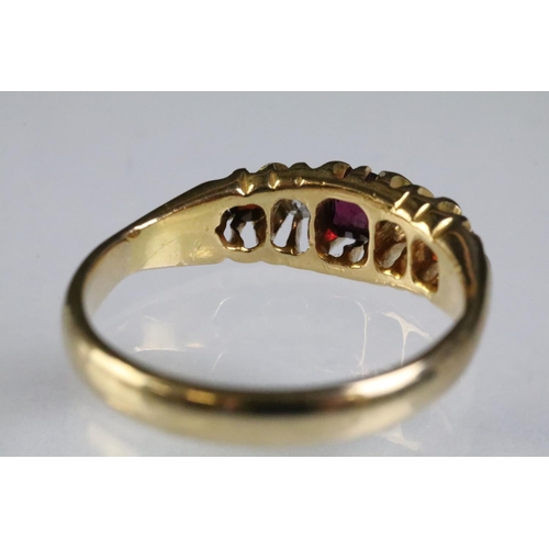 311 - 9ct gold garnet and diamond five stone ring. The ring being set with three round cut garnets with tw... 