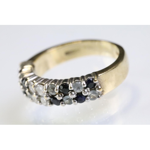 313 - 9ct gold gemstone ring set with two rows of round cut stones including four diamonds to centre flank... 