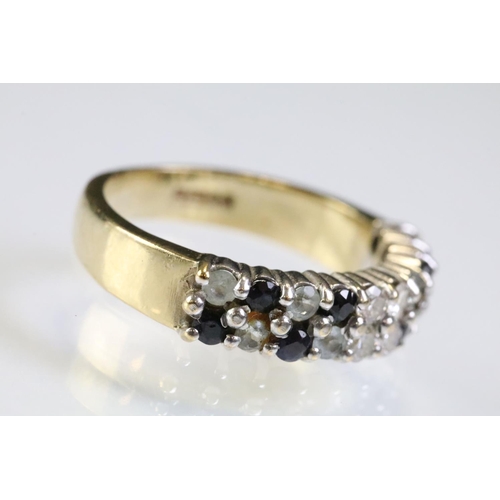 313 - 9ct gold gemstone ring set with two rows of round cut stones including four diamonds to centre flank... 