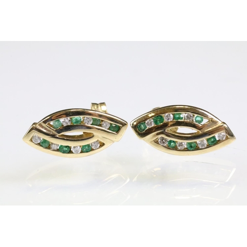 314 - Pair of 9ct gold emerald and diamond stud earrings. The heads having two channels of round cut emera... 