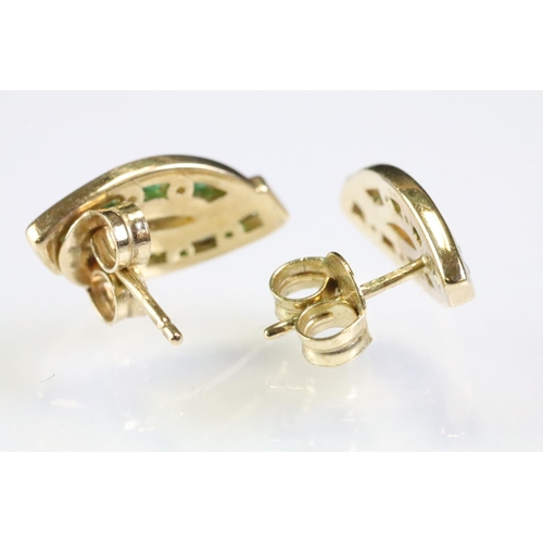 314 - Pair of 9ct gold emerald and diamond stud earrings. The heads having two channels of round cut emera... 