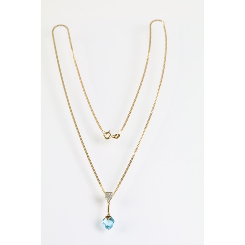 319 - 9ct gold diamond and topaz pendant necklace. The necklace having a briolette cut blue topaz drop sus... 