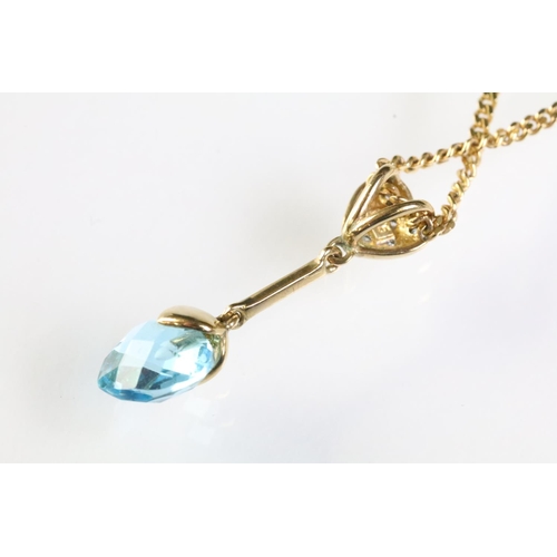 319 - 9ct gold diamond and topaz pendant necklace. The necklace having a briolette cut blue topaz drop sus... 