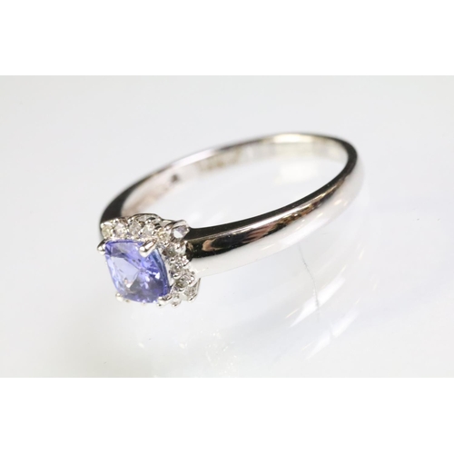 32 - 18ct white gold and tanzanite ring being set with a square cushion cut tanzanite to the head within ... 