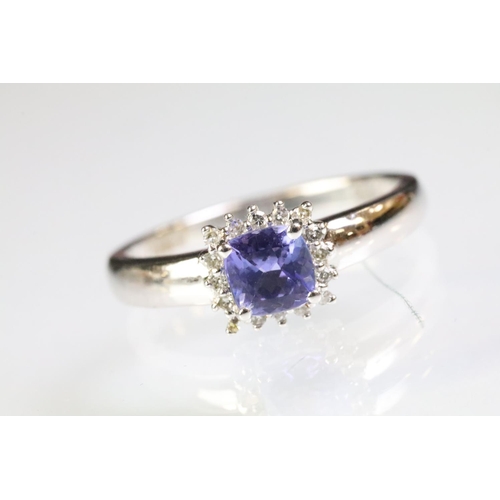 32 - 18ct white gold and tanzanite ring being set with a square cushion cut tanzanite to the head within ... 