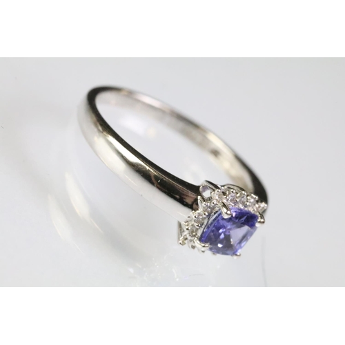 32 - 18ct white gold and tanzanite ring being set with a square cushion cut tanzanite to the head within ... 