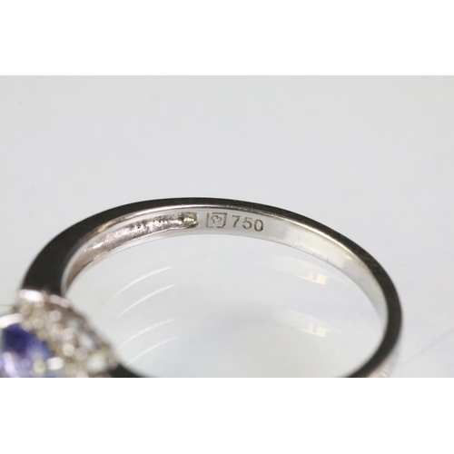 32 - 18ct white gold and tanzanite ring being set with a square cushion cut tanzanite to the head within ... 