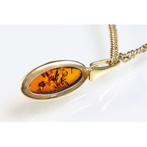 323 - 9ct gold flat link necklace chain having an 18ct gold oval amber pendant, together with a pair of 18... 