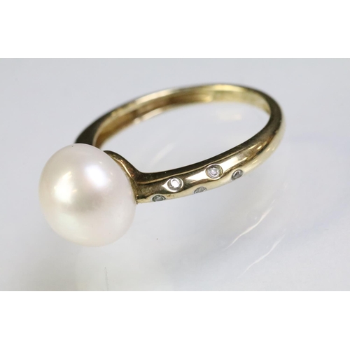 35 - 9ct gold hallmarked, cultured pearl and diamond ring being set with a white pearl to the head with d... 