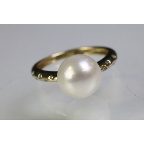 35 - 9ct gold hallmarked, cultured pearl and diamond ring being set with a white pearl to the head with d... 