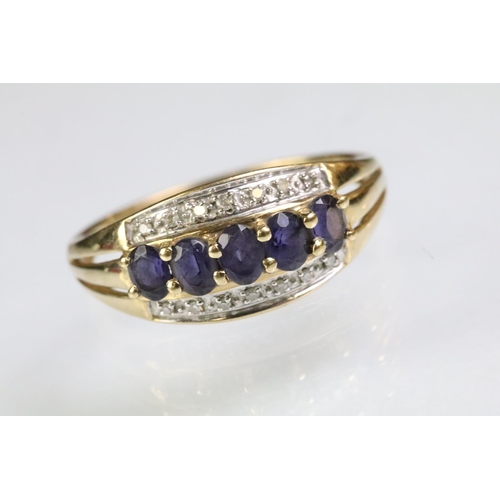 62 - Hallmarked 9ct gold purple stone and diamond ring. The ring being set with five oval cut purple ston... 