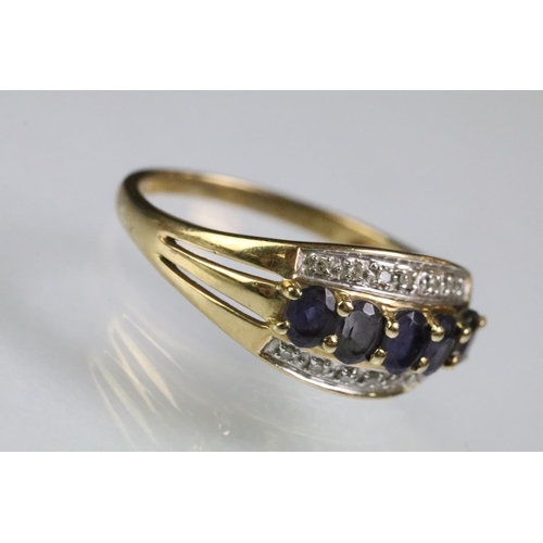 62 - Hallmarked 9ct gold purple stone and diamond ring. The ring being set with five oval cut purple ston... 