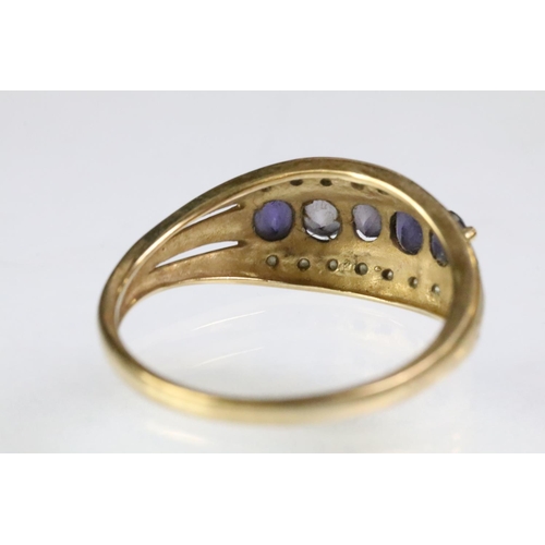 62 - Hallmarked 9ct gold purple stone and diamond ring. The ring being set with five oval cut purple ston... 