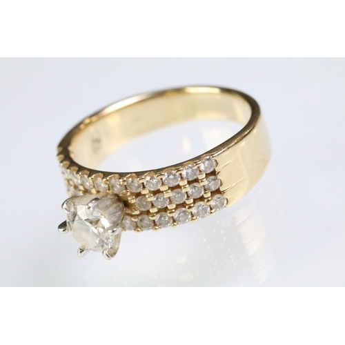 74 - 14ct gold and diamond ring. The ring being prong set with a round brilliant cut diamond with three r... 