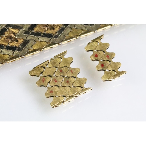 83 - 18ct gold tri tone bracelet constructed with tesselating links forming a diamond shape pattern with ... 