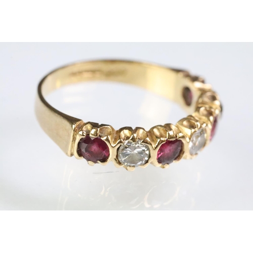 90 - 18ct gold, ruby and diamond seven stone ring. The ring being set with three round cut diamonds, and ... 