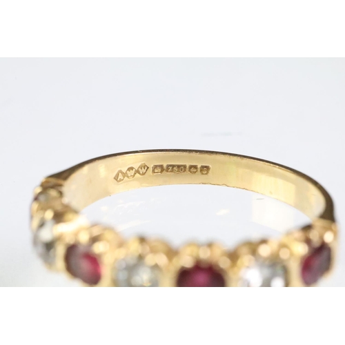 90 - 18ct gold, ruby and diamond seven stone ring. The ring being set with three round cut diamonds, and ... 