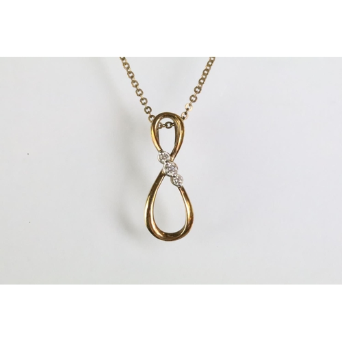 93 - 9ct gold and diamond pendant necklace. The necklace having a fine link chain with figure of eight in... 