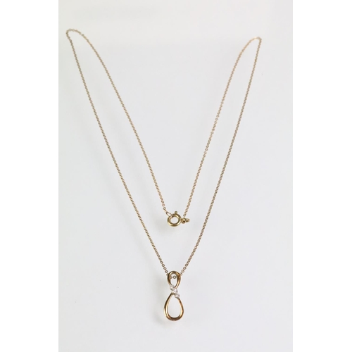 93 - 9ct gold and diamond pendant necklace. The necklace having a fine link chain with figure of eight in... 