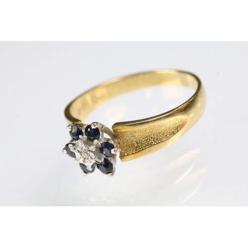 94 - Hallmarked 18ct gold sapphire and diamond cluster ring having textured shoulders. Hallmarked London ... 