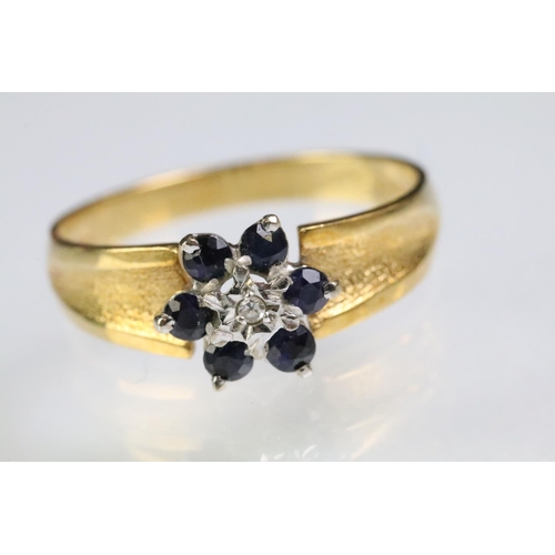 94 - Hallmarked 18ct gold sapphire and diamond cluster ring having textured shoulders. Hallmarked London ... 