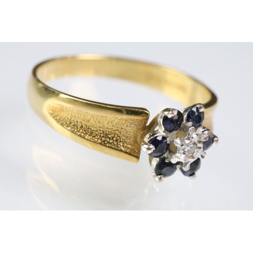 94 - Hallmarked 18ct gold sapphire and diamond cluster ring having textured shoulders. Hallmarked London ... 