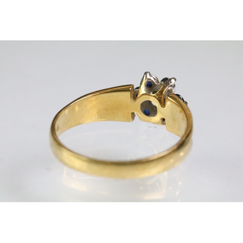 94 - Hallmarked 18ct gold sapphire and diamond cluster ring having textured shoulders. Hallmarked London ... 