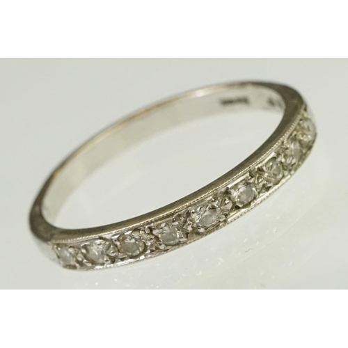 103 - Diamond half eternity ring being set with nine round cut diamonds. Marked 18ct to shank.