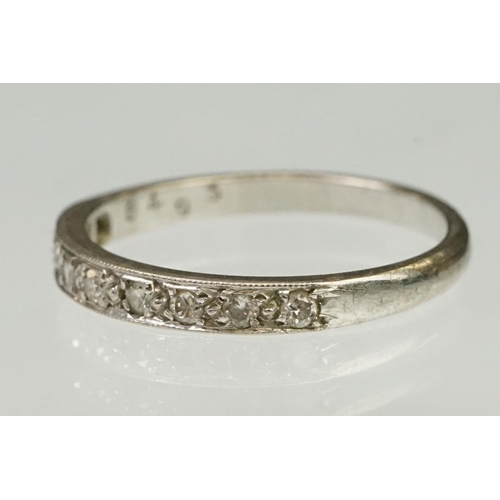 103 - Diamond half eternity ring being set with nine round cut diamonds. Marked 18ct to shank.