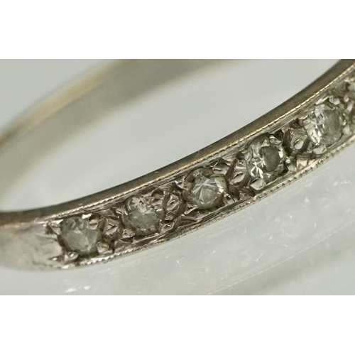 103 - Diamond half eternity ring being set with nine round cut diamonds. Marked 18ct to shank.