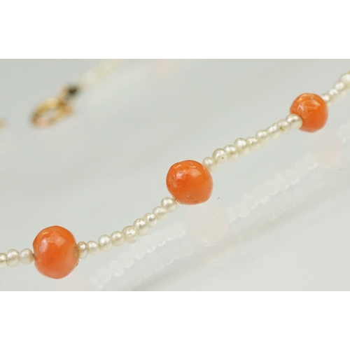 104 - Coral and seed pearl beaded necklace being strung with round coral beads with small seed pearls and ... 