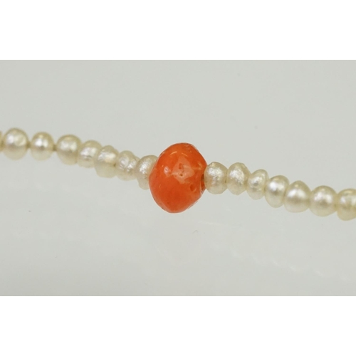 104 - Coral and seed pearl beaded necklace being strung with round coral beads with small seed pearls and ... 