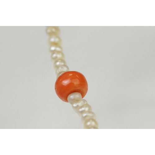 104 - Coral and seed pearl beaded necklace being strung with round coral beads with small seed pearls and ... 