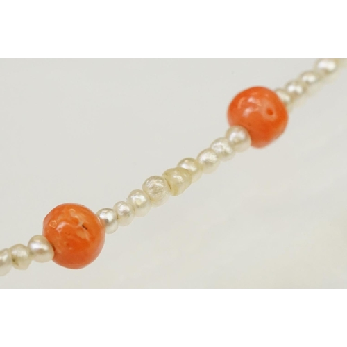 104 - Coral and seed pearl beaded necklace being strung with round coral beads with small seed pearls and ... 