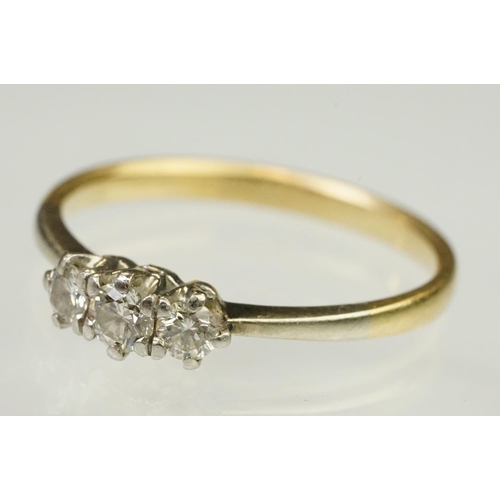 105 - Three stone diamond ring being set with three round brilliant cut diamonds in prong settings with wh... 