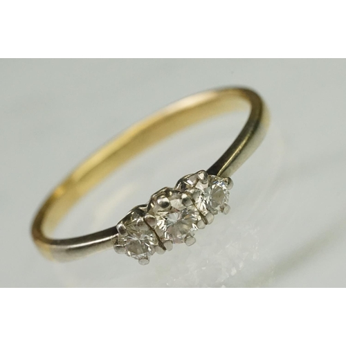 105 - Three stone diamond ring being set with three round brilliant cut diamonds in prong settings with wh... 