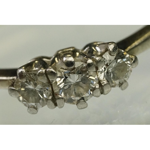 105 - Three stone diamond ring being set with three round brilliant cut diamonds in prong settings with wh... 