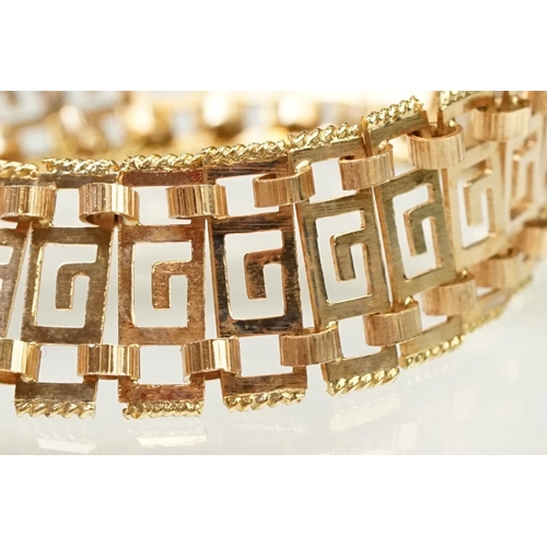 106 - 14ct gold greek key panel bracelet with pierced details to each link, with box clasp. Marked 585 to ... 