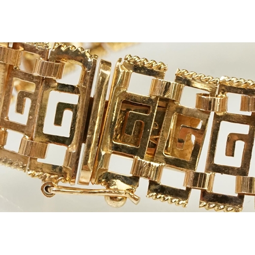 106 - 14ct gold greek key panel bracelet with pierced details to each link, with box clasp. Marked 585 to ... 