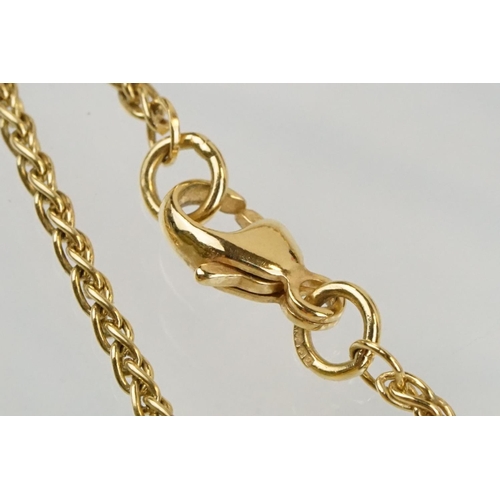 11 - 18ct gold and diamond pendant necklace. The pendant of swirl design being set with a round fancy cut... 