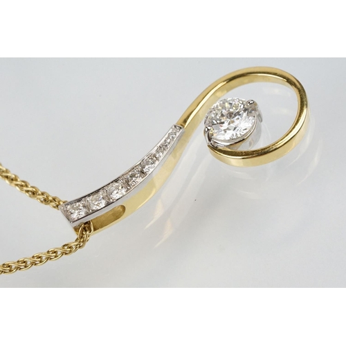 11 - 18ct gold and diamond pendant necklace. The pendant of swirl design being set with a round fancy cut... 