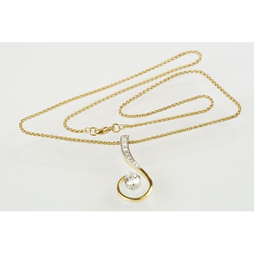 11 - 18ct gold and diamond pendant necklace. The pendant of swirl design being set with a round fancy cut... 