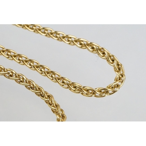 11 - 18ct gold and diamond pendant necklace. The pendant of swirl design being set with a round fancy cut... 