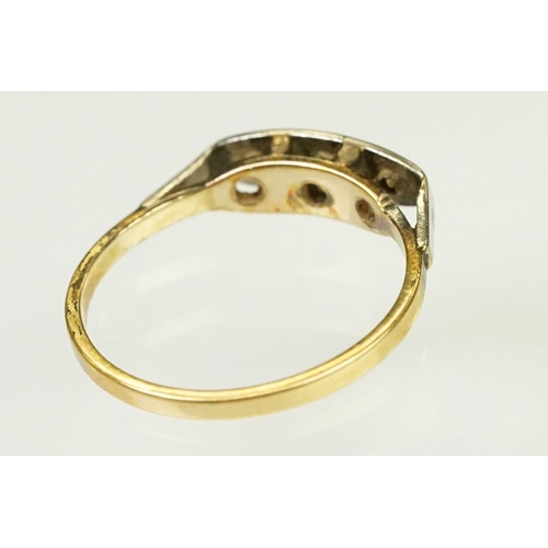 117 - Two Art Deco era gold rings to include an 18ct gold boat head ring set with three diamonds (marked 1... 