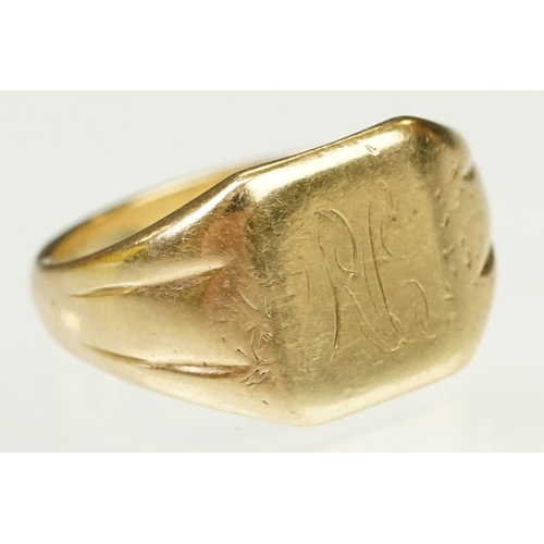 122 - 9ct gold signet ring having a square head with reeded shoulders. Marked 9ct to shank. Head engraved ... 