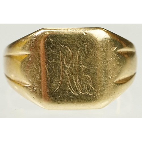 122 - 9ct gold signet ring having a square head with reeded shoulders. Marked 9ct to shank. Head engraved ... 